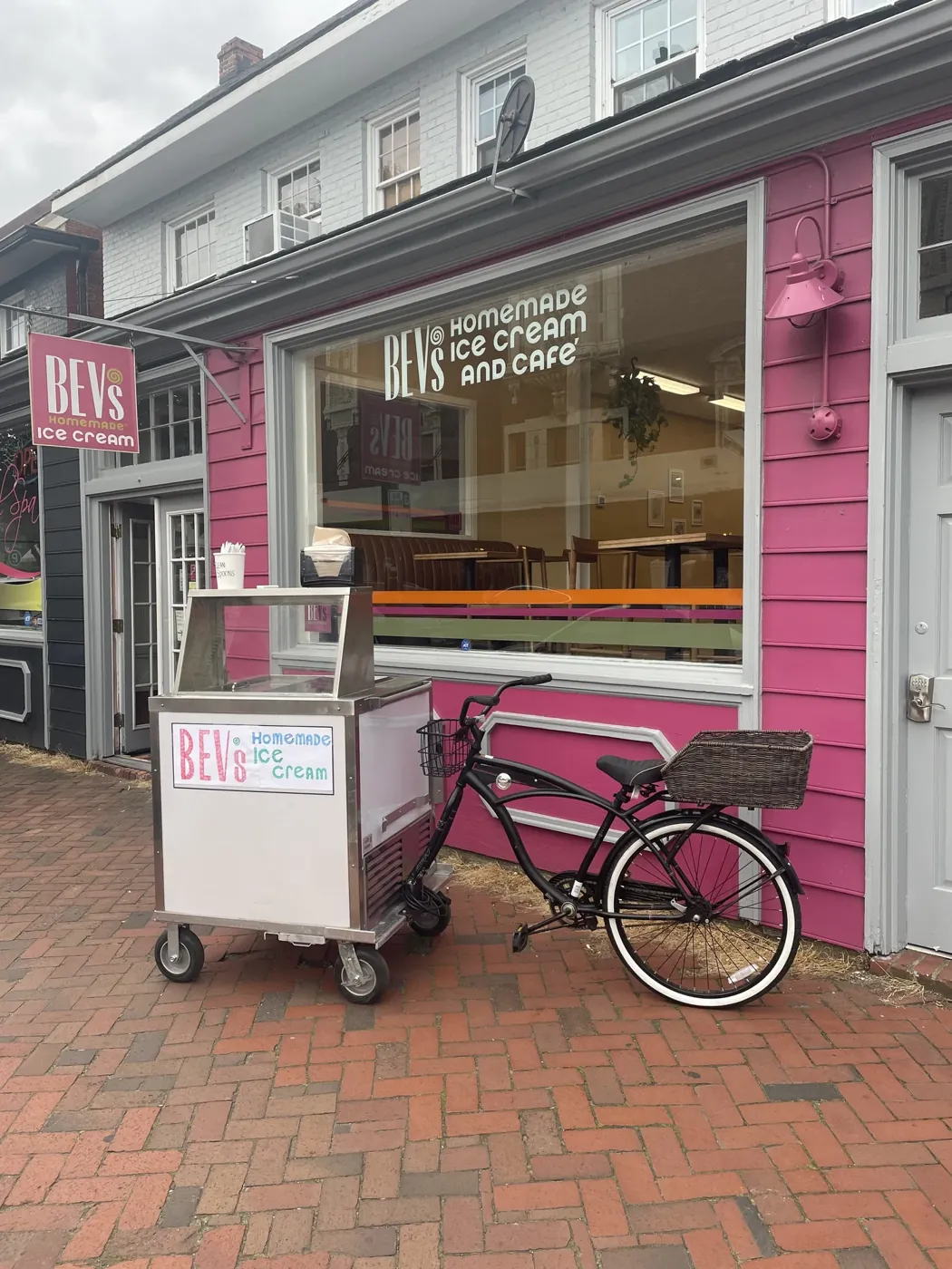 Bev’s pink storefront on West Cary Street with the ice cream cart and a bicycle out front