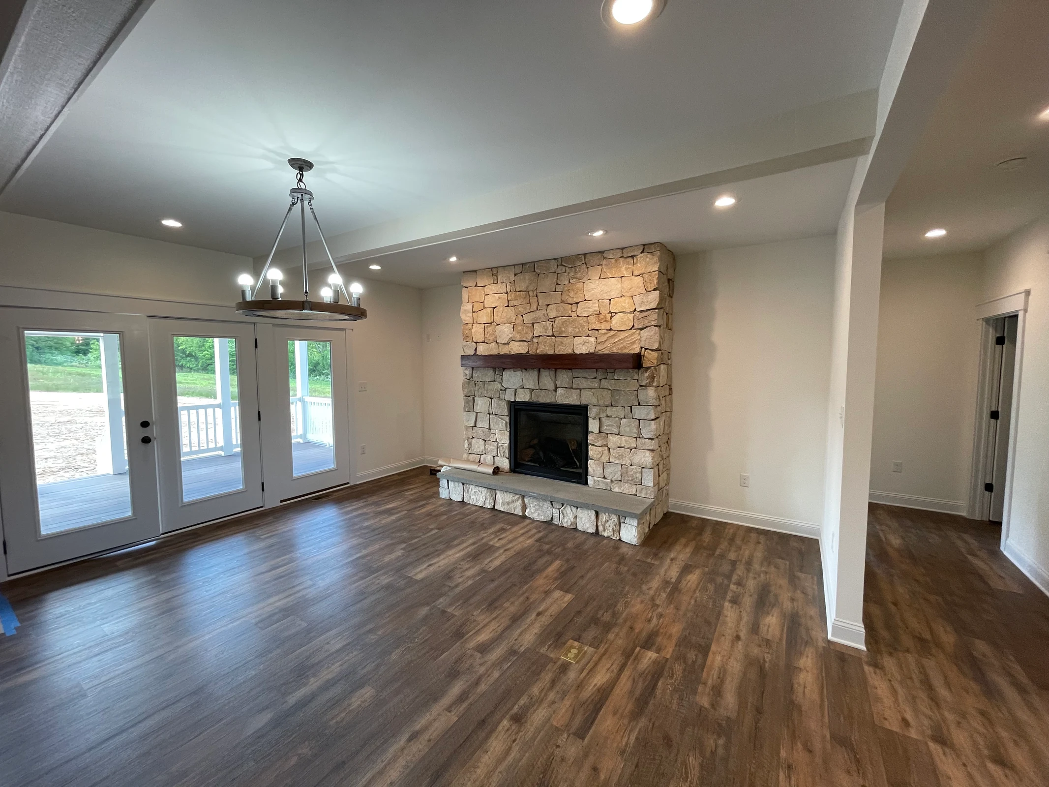 Finished Hamlin Homes living room with a stone fireplace