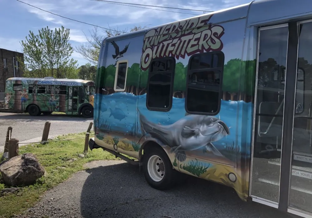 The Riverside Outfitters shuttle bus, painted with a river mural