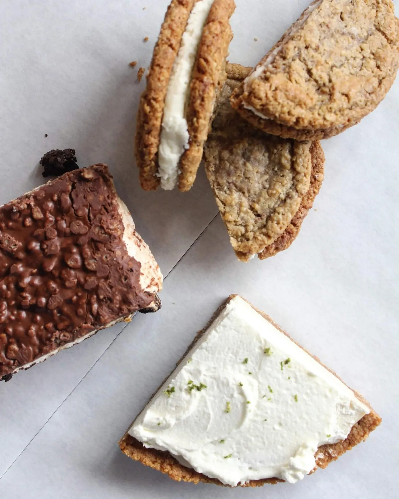 Oatmeal cream pie sandwiches beside a Swamp Bar and a slice of key lime pie