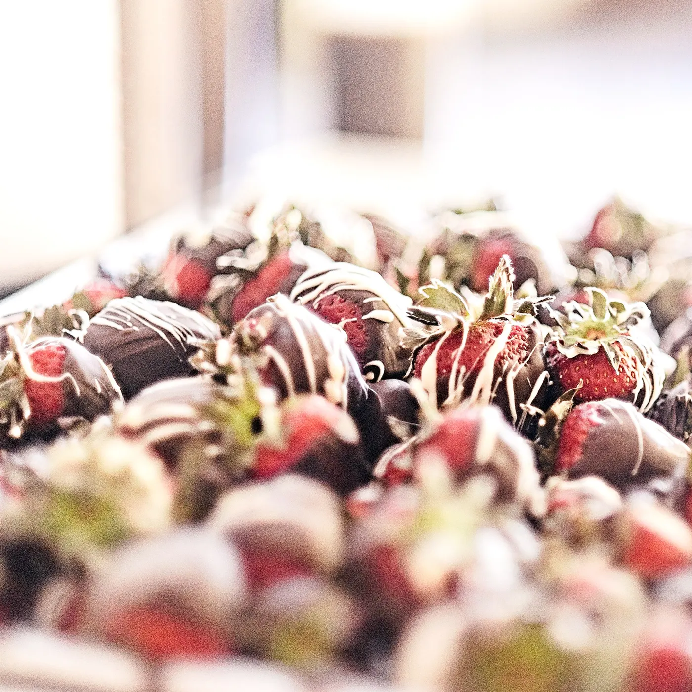 A tray of strawberries dipped in dark and white chocolate