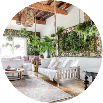 A living room with a hanging swing bed and a living plant wall