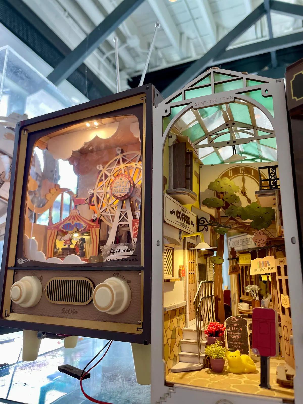 A glowing miniature carousel and dollhouse-style book nooks in the gift shop